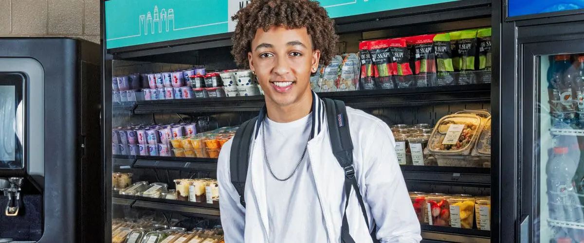 Student smiling in the middle of c-store